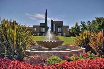 Community Outdoor Green Space with Stone Fountain, Flower Bed, Plants, Apartment Exteriors at Fountains of Fair Oaks, California, 95628